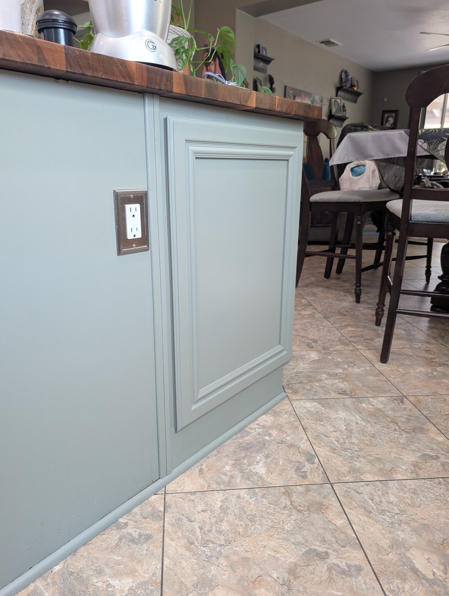 Kitchen island end panel with matching painted cabinet door hiding a trash pull-out in Menifee, CA