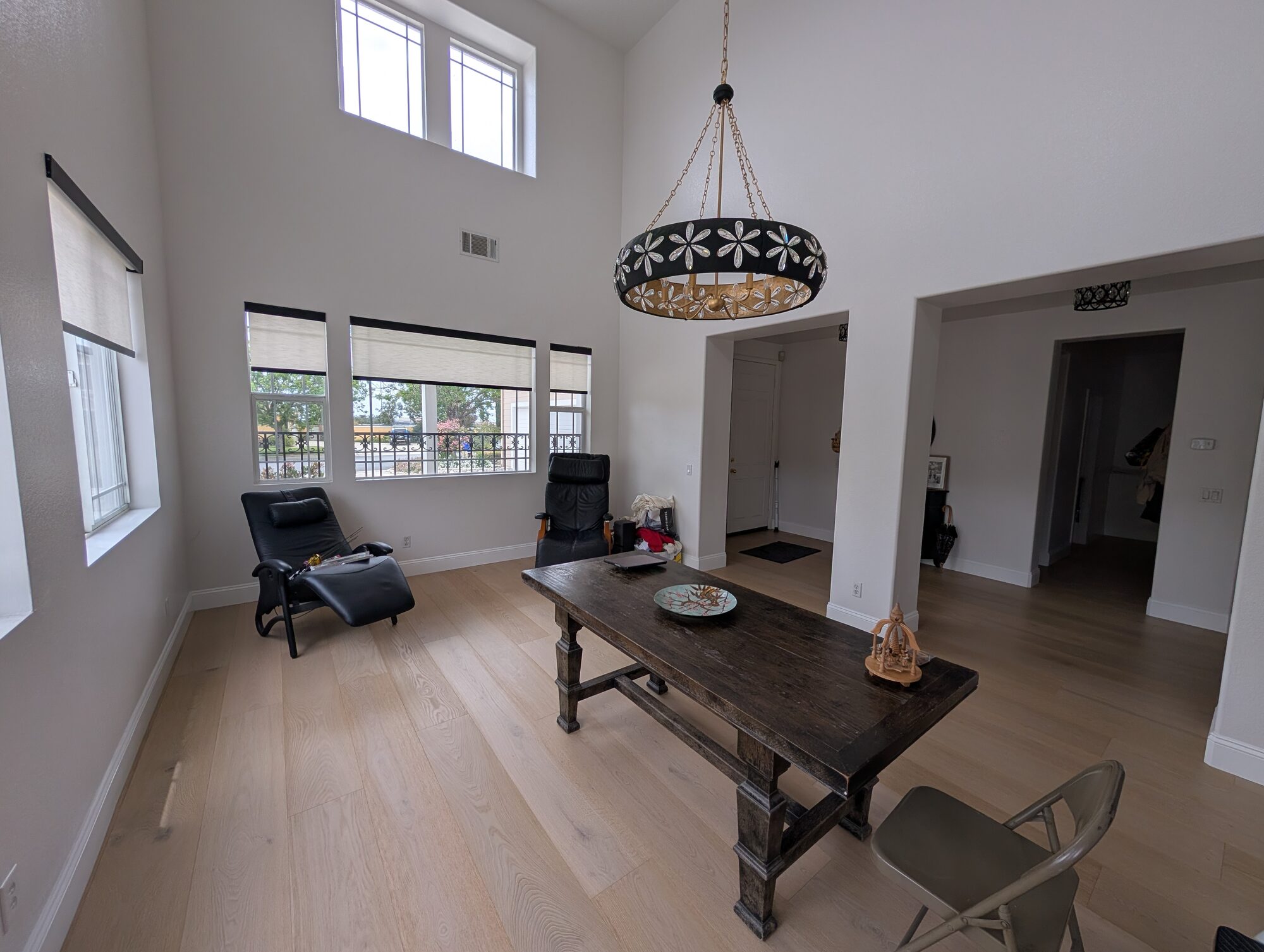 Formal dining room before wainscoting in Rancho Cucamonga, large front windows and plain drywall walls