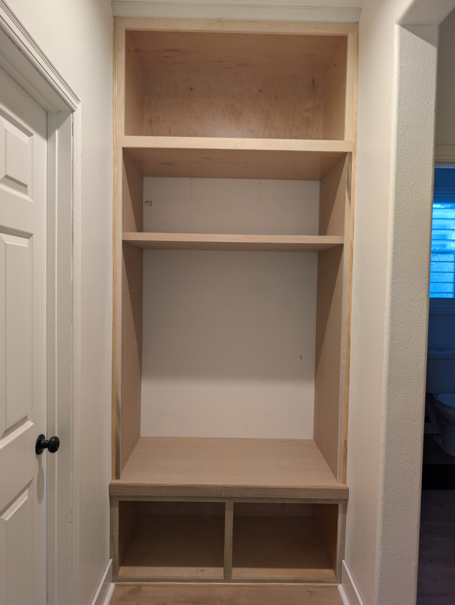 Maple face frame built in and scribed to the out-of-square niche walls, still bare before paint, Winchester CA