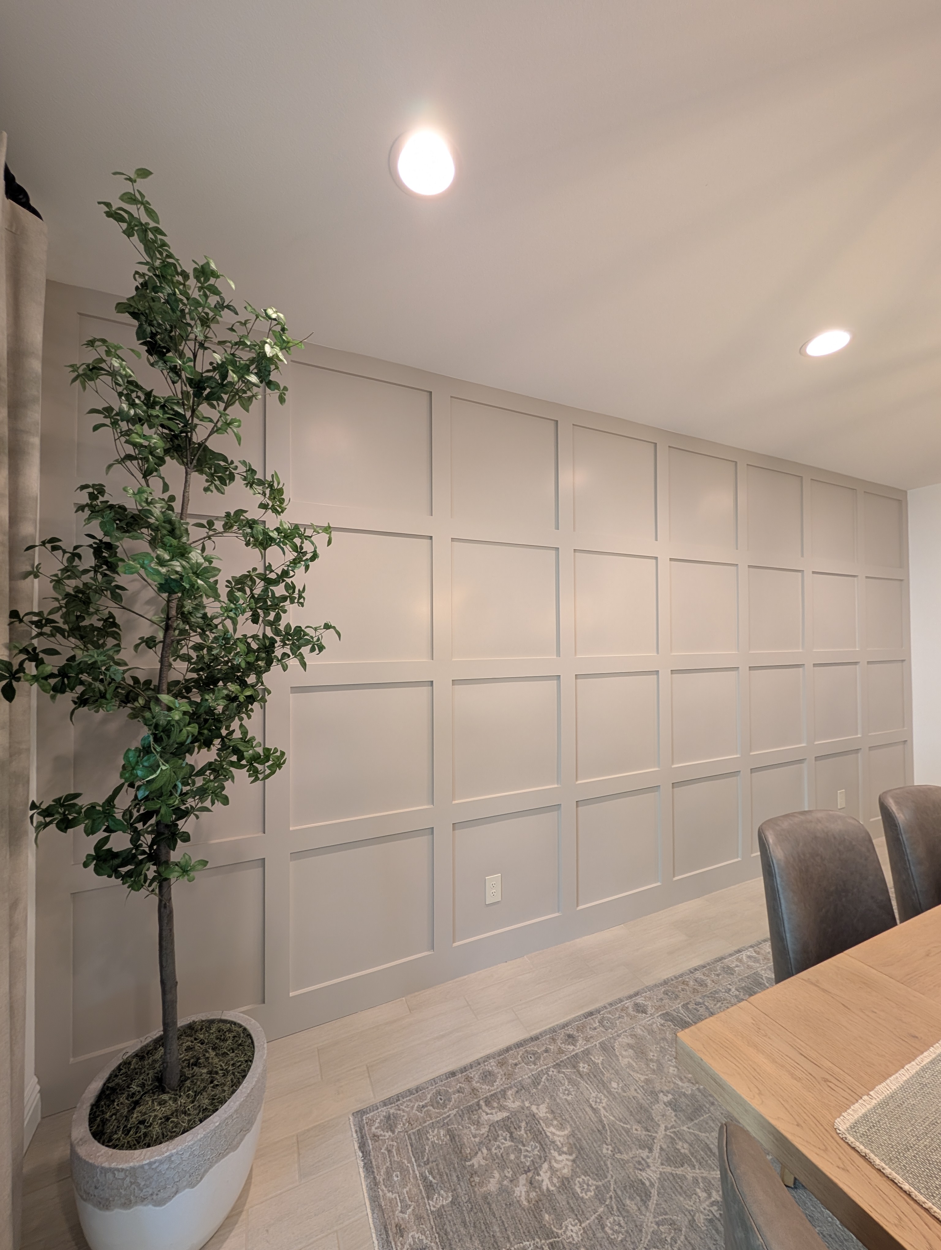 The finished wall running the full length of the dining room, corner to corner