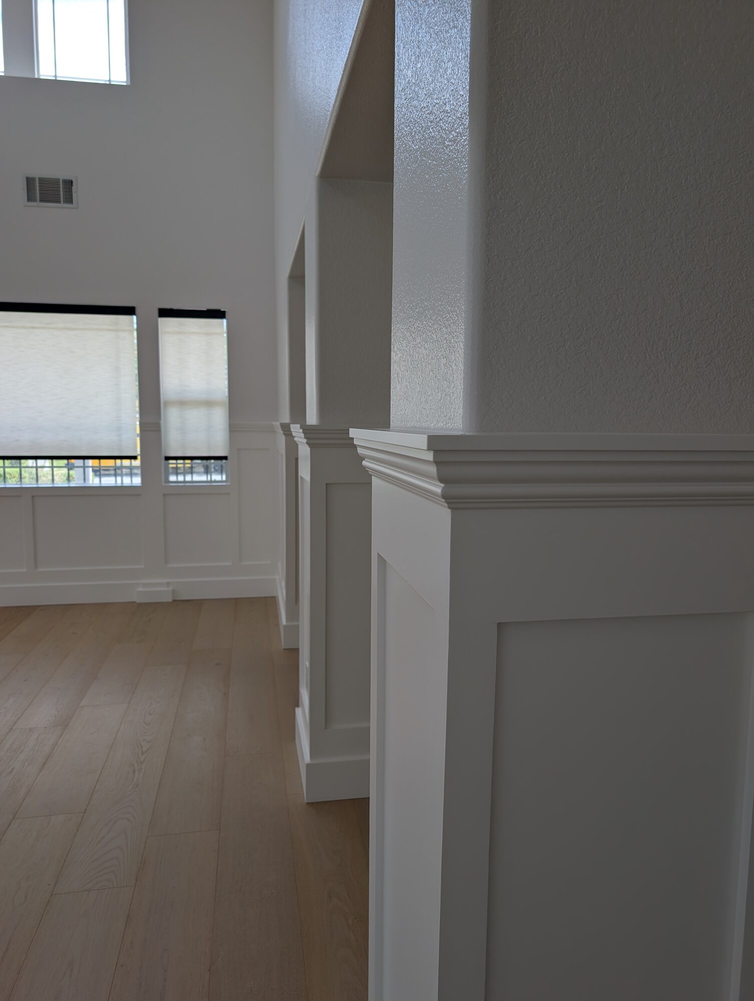 Close-up of molded column cap on paint-grade wainscoting in Pure White satin, Rancho Cucamonga