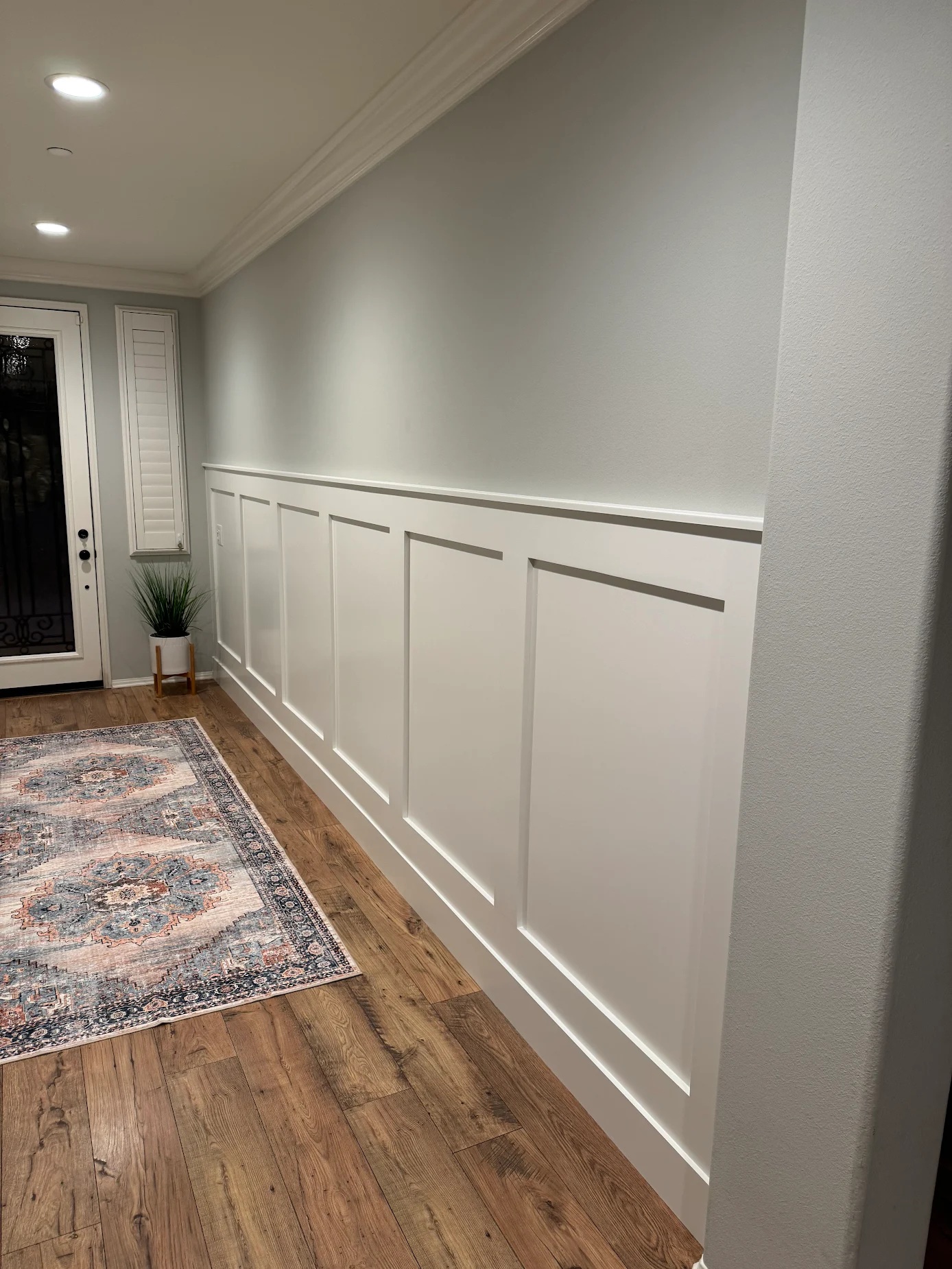 Finished white board-and-batten wainscoting in a styled Menifee entry hallway