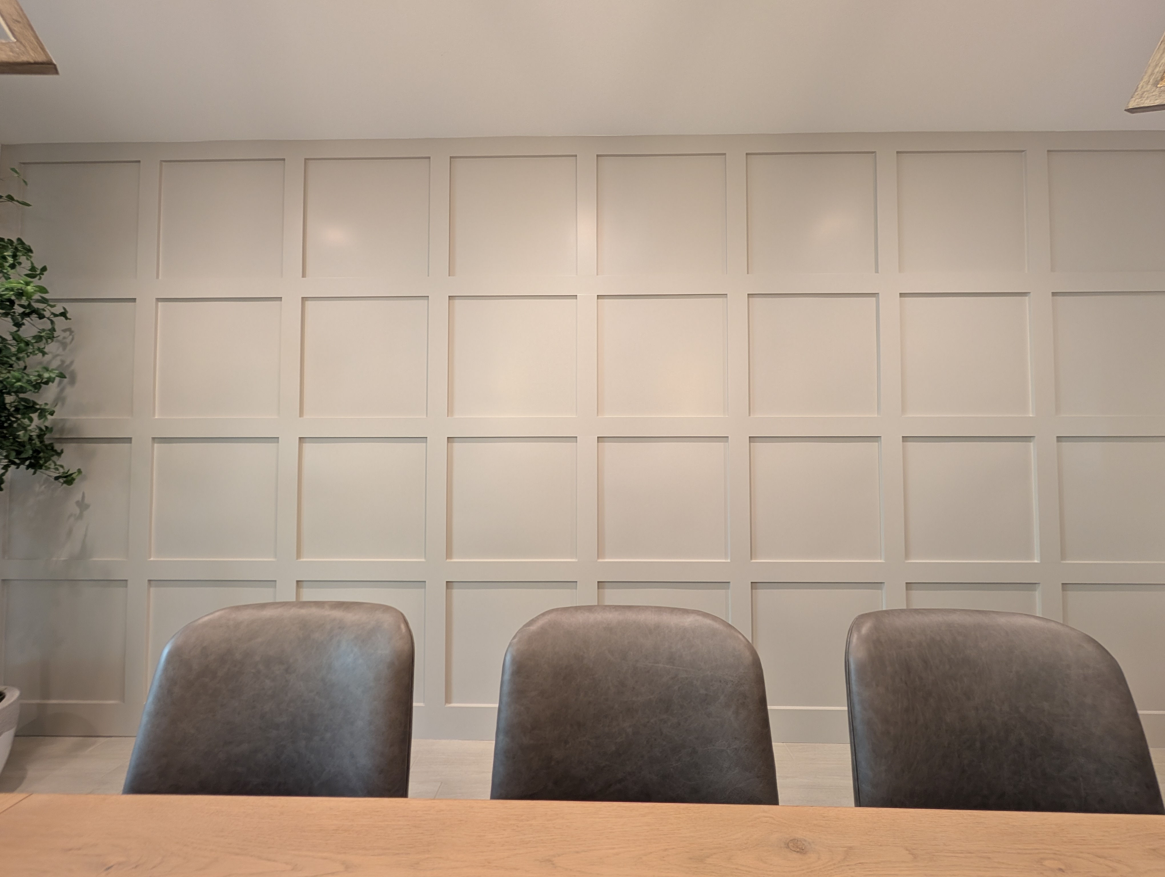 Finished gray 8-by-4 grid accent wall in a Menifee dining room, straight-on view of the even panel reveals.
