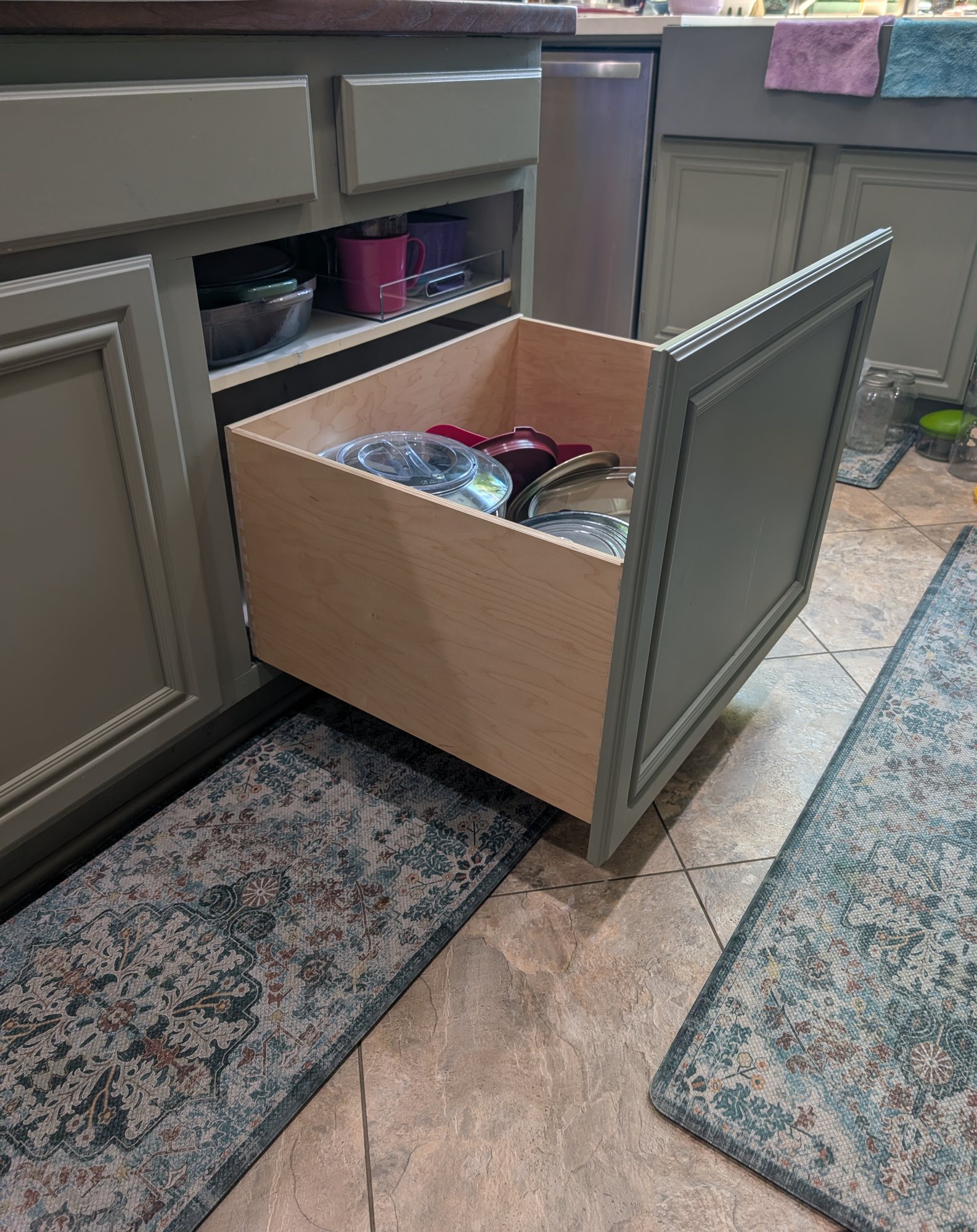 Deep dovetailed pull-out drawer holding pots and lids on soft-close slides, Menifee CA kitchen