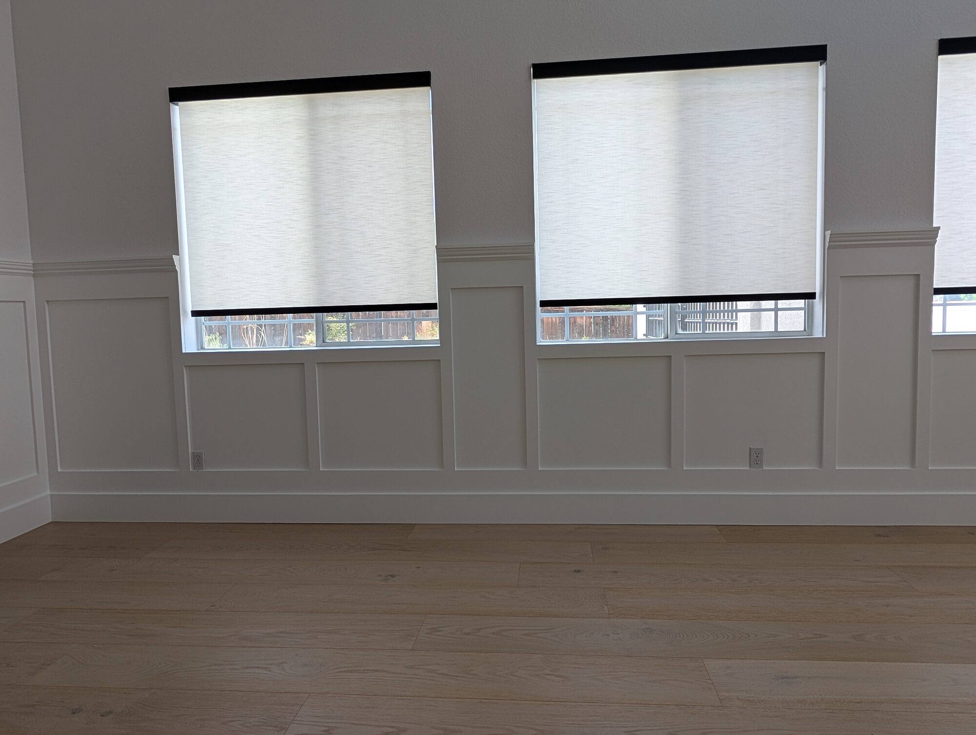 Wainscoting panels laid out under two different-size windows in a Rancho Cucamonga dining room