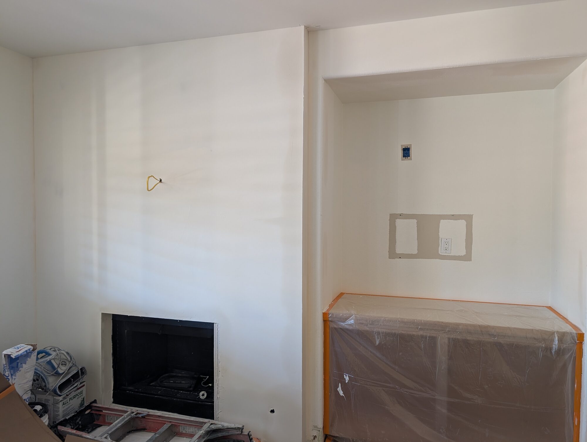 Fireplace wall drywalled smooth and the new built-in masked off before the Roman Clay goes on, Winchester CA