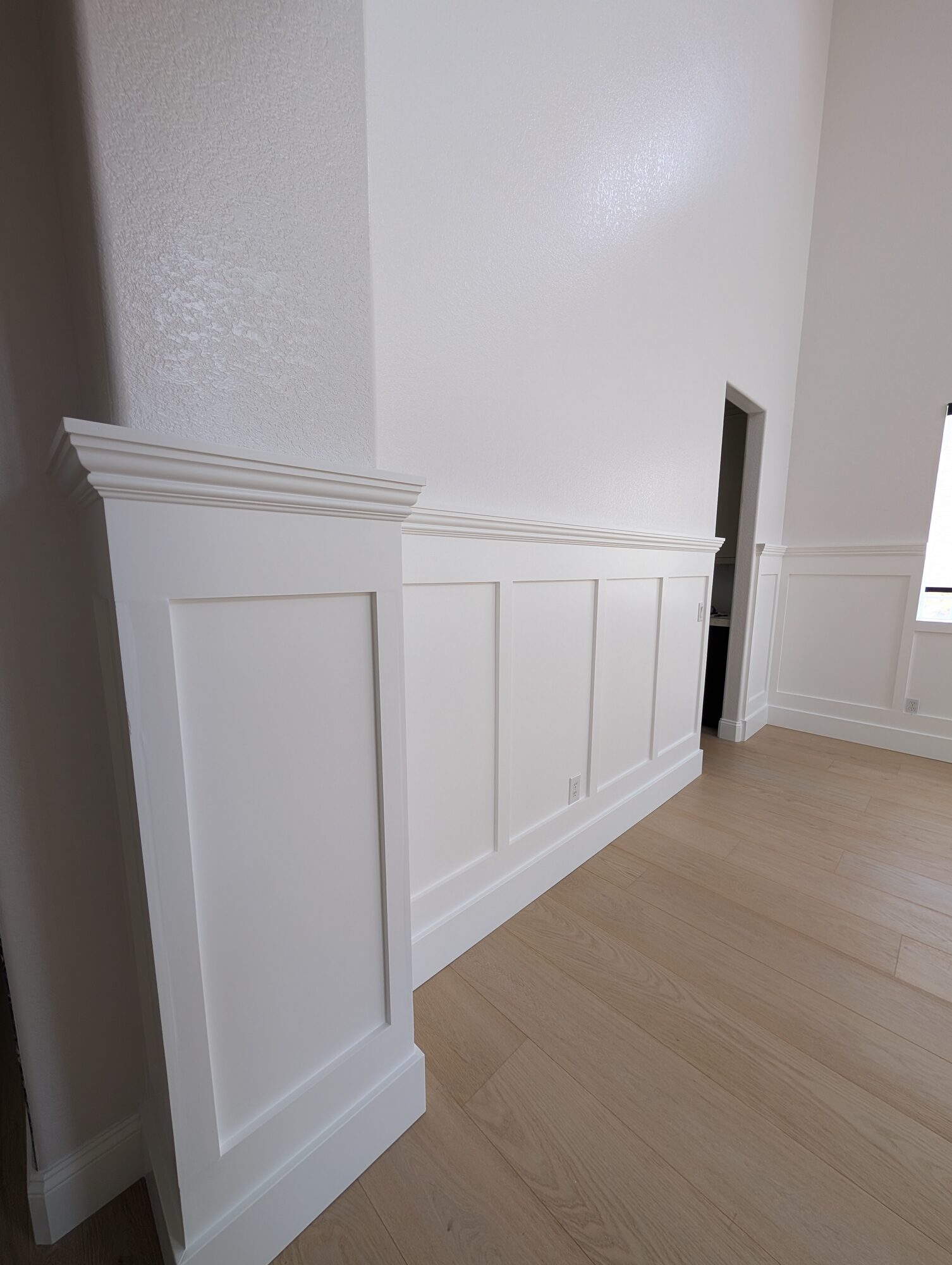 Wainscoting end pilaster with stepped pediment cap in a Rancho Cucamonga dining room