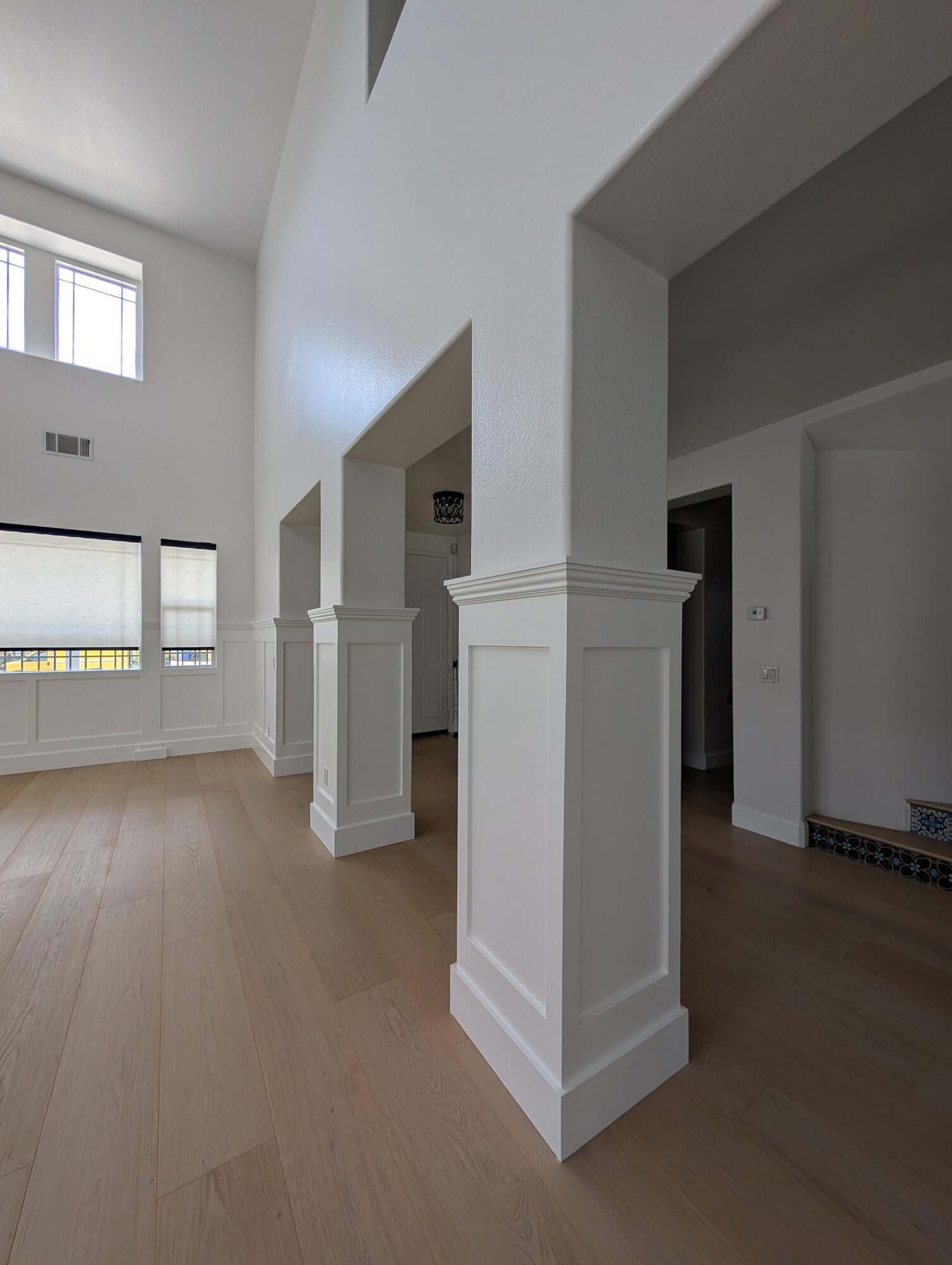 Three paneled column wraps with molded caps between entry hall and dining room, Rancho Cucamonga